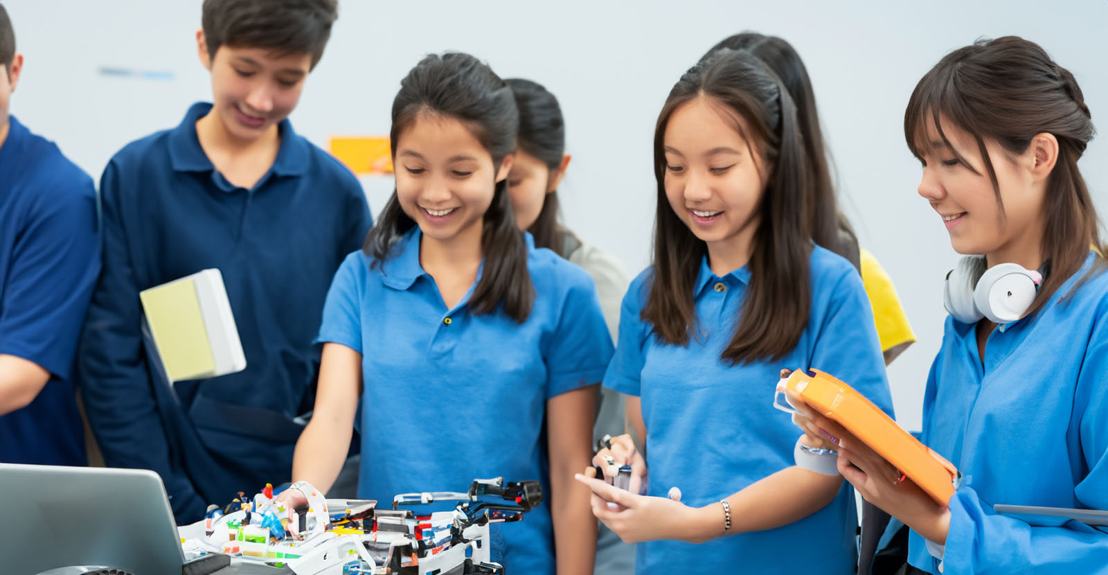 Eine Gruppe Studenten betrachtet einen Roboter